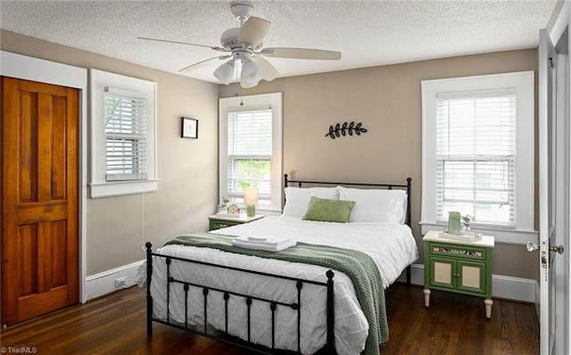 609 W Lexington Ave, High Point, NC 27262 - bedroom featuring wood finished floors, multiple windows, a textured ceiling, and ceiling fan
