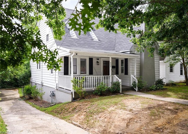 609 W Lexington Ave, High Point, NC 27262 - cape cod home featuring a porch and a shingled roof