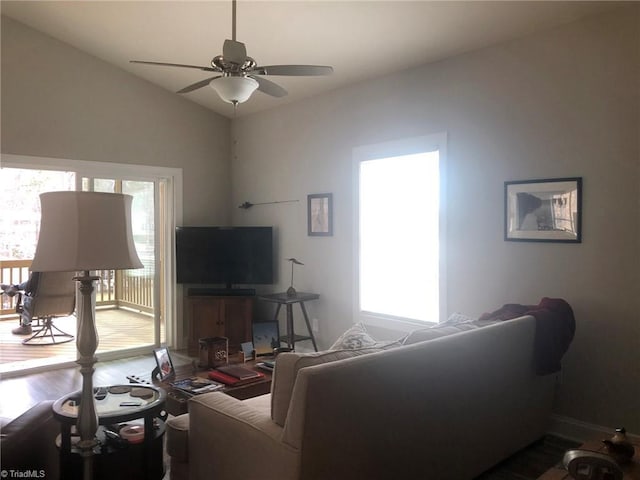 living room with vaulted ceiling, wood finished floors, a ceiling fan, and a healthy amount of sunlight