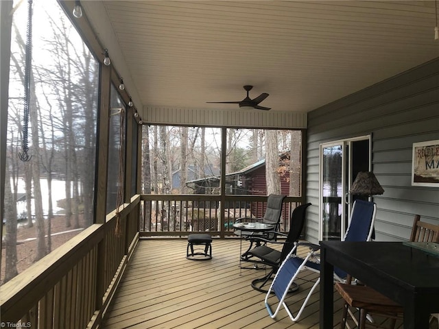 sunroom / solarium featuring ceiling fan and a wealth of natural light