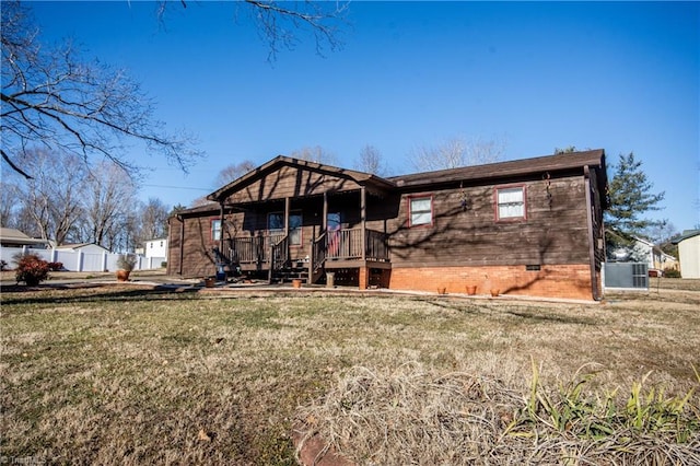 back of property featuring a porch and a lawn