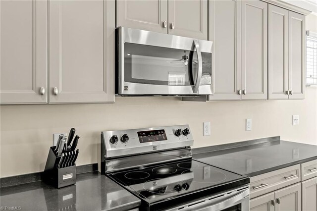 kitchen featuring appliances with stainless steel finishes and white cabinets