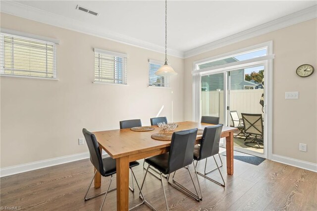 dining area featuring ornamental molding and hardwood / wood-style flooring