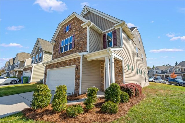 view of front of home featuring a garage and a front lawn