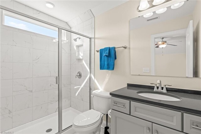 bathroom with toilet, walk in shower, vanity, and ceiling fan