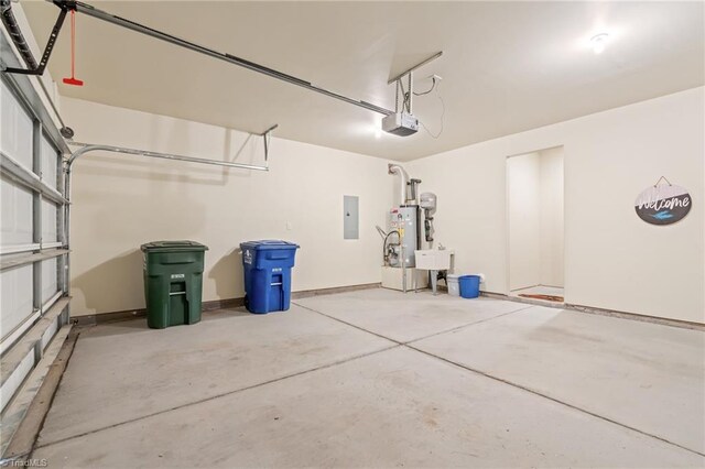 garage featuring a garage door opener, water heater, electric panel, and sink