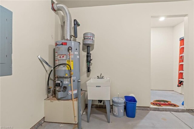 utility room with electric panel, sink, and gas water heater