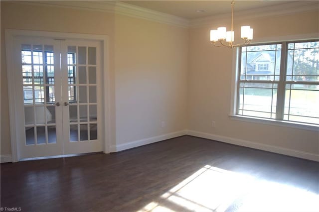 unfurnished room with a notable chandelier, baseboards, french doors, crown molding, and dark wood finished floors