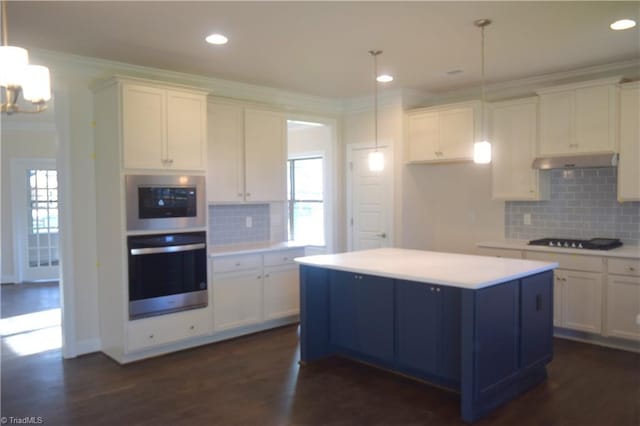 kitchen with dark wood finished floors, ornamental molding, white cabinetry, under cabinet range hood, and black stovetop