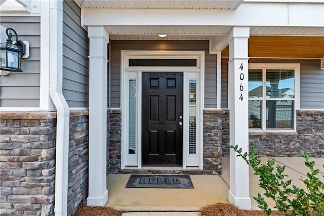 view of exterior entry with a porch