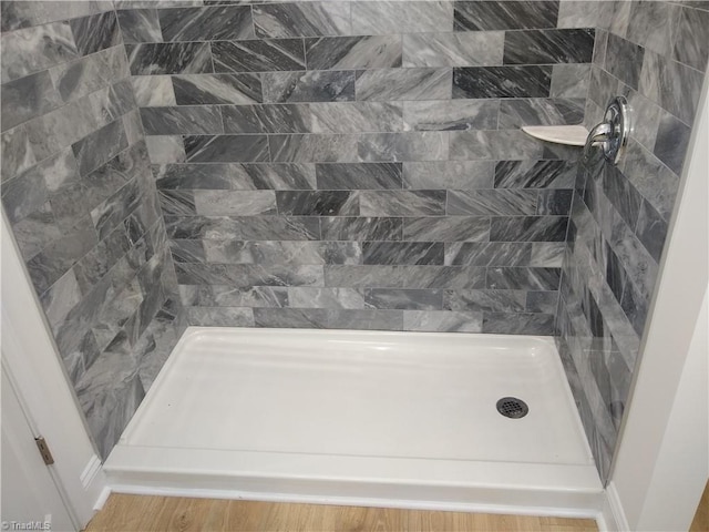 bathroom featuring hardwood / wood-style floors and walk in shower