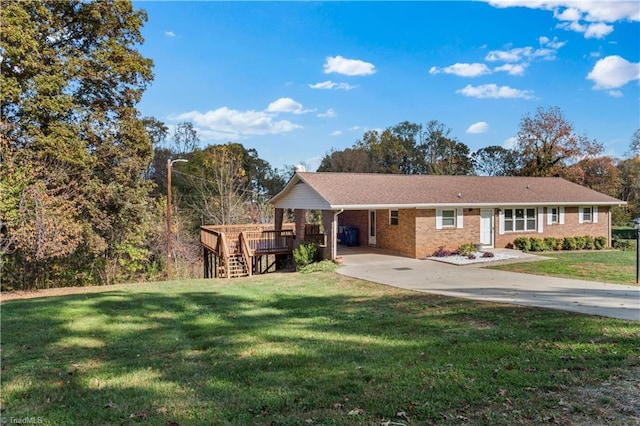 single story home with a wooden deck and a front yard