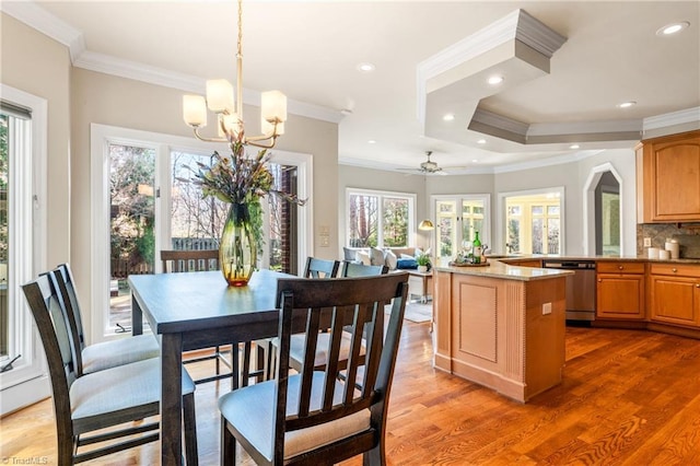 dining room featuring recessed lighting, a healthy amount of sunlight, light wood-type flooring, and ornamental molding