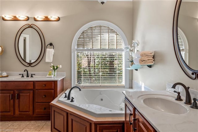 full bath with tile patterned floors, plenty of natural light, and a sink