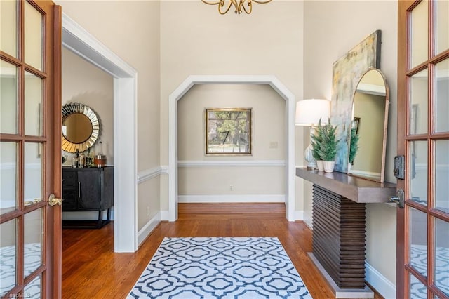 entrance foyer featuring wood finished floors, french doors, and baseboards