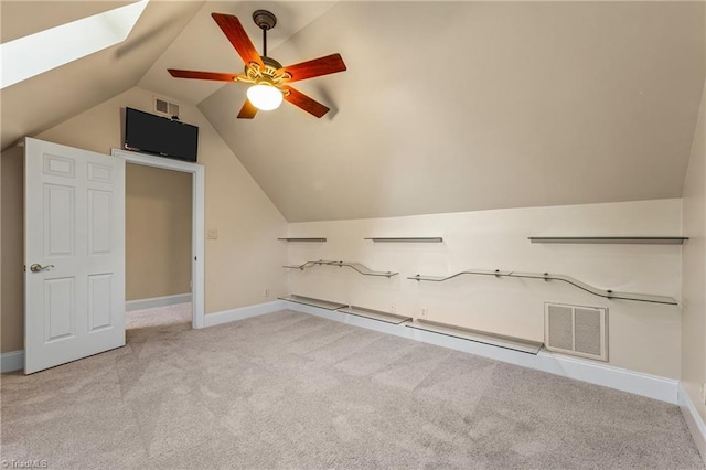 bonus room with visible vents, lofted ceiling with skylight, carpet floors, baseboards, and ceiling fan