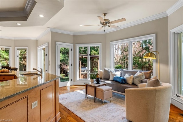 living room featuring crown molding, recessed lighting, and light wood finished floors