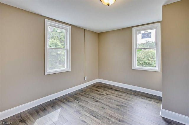 unfurnished room with hardwood / wood-style flooring