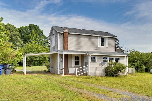 back of house featuring a yard