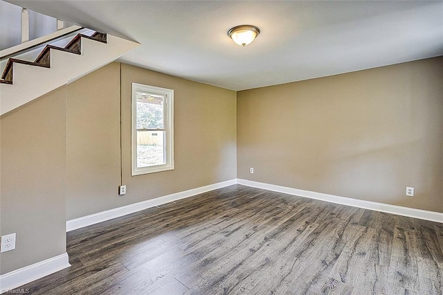 additional living space with dark wood-type flooring and vaulted ceiling