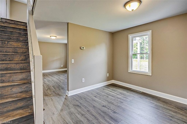 empty room with hardwood / wood-style flooring