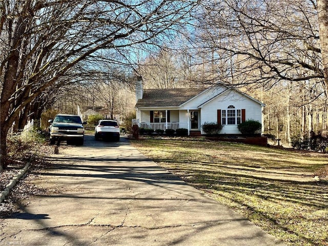 view of front of property with covered porch and a front yard