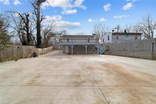 exterior space with a garage and a wooden deck