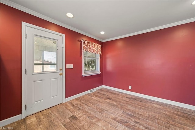 foyer featuring ornamental molding, recessed lighting, wood finished floors, and baseboards