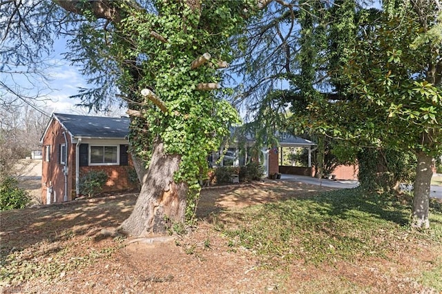 obstructed view of property featuring a carport and brick siding