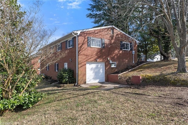 back of house featuring brick siding and an attached garage