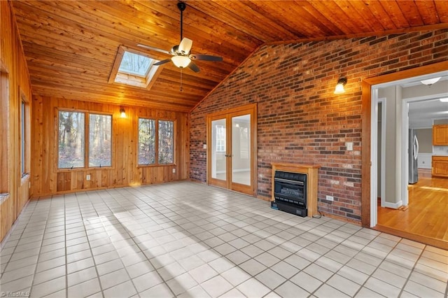 unfurnished living room featuring french doors, brick wall, wood walls, light tile patterned flooring, and wood ceiling