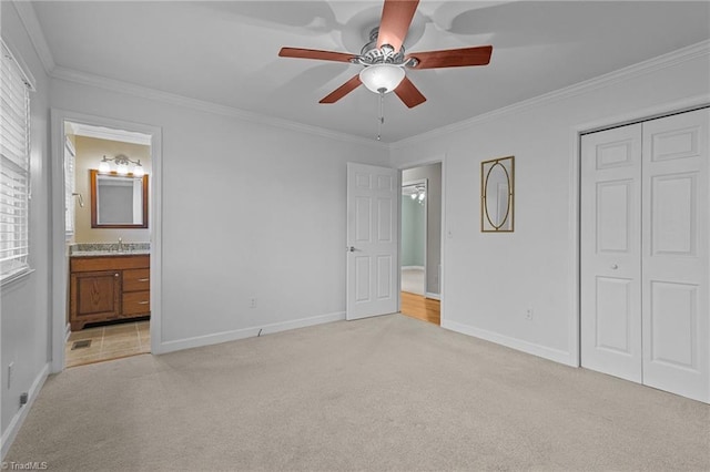 unfurnished bedroom featuring light carpet, connected bathroom, and ceiling fan