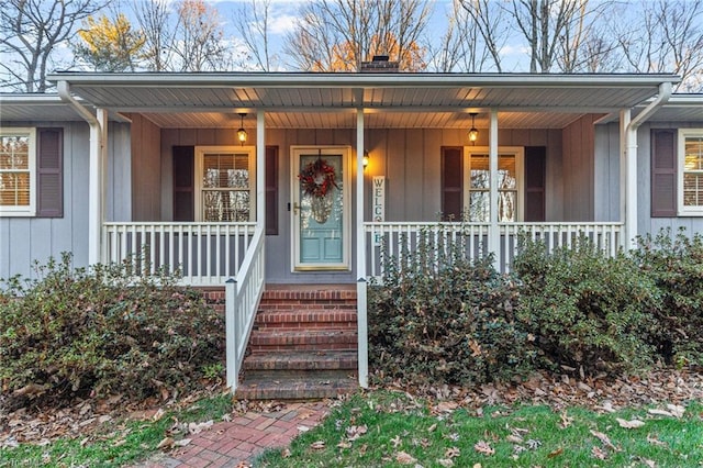 view of exterior entry with covered porch