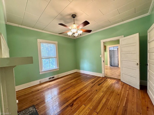 unfurnished bedroom featuring crown molding, hardwood / wood-style flooring, and ceiling fan