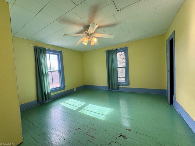 spare room featuring hardwood / wood-style flooring and ceiling fan