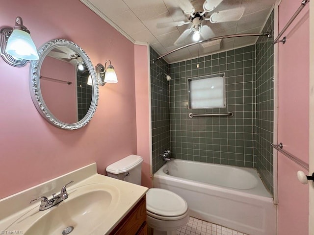 full bathroom featuring ceiling fan, tile patterned flooring, tiled shower / bath combo, vanity, and toilet