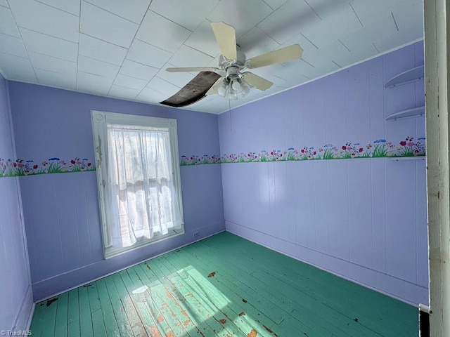 spare room featuring hardwood / wood-style flooring and ceiling fan