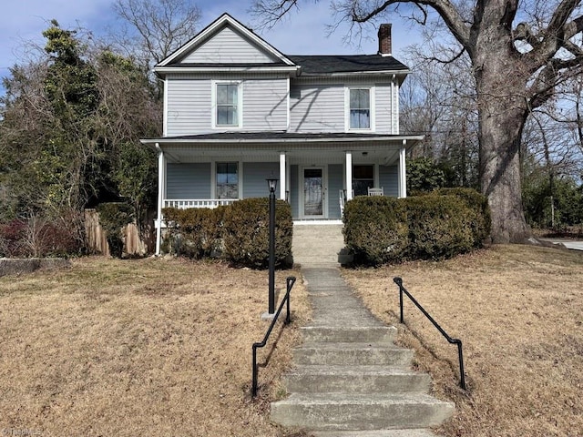 view of front property featuring a porch and a front yard