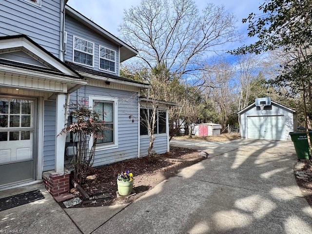 view of side of property featuring a garage and an outdoor structure