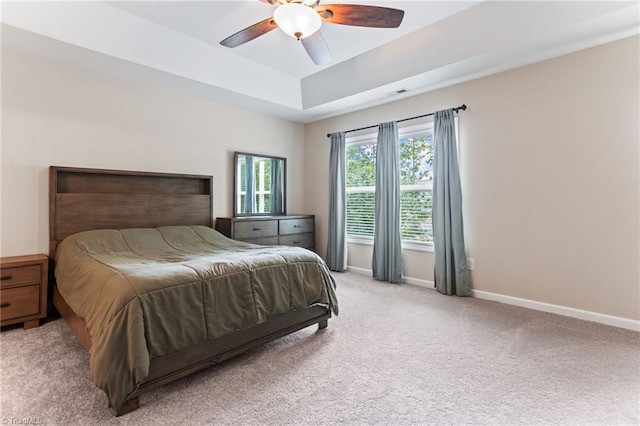 822 Blue Lake Dr, Mebane, NC 27302 - bedroom with light carpet, a tray ceiling, and a ceiling fan