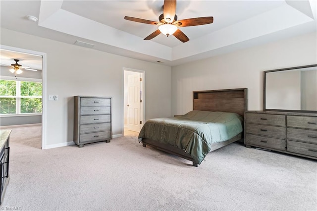 822 Blue Lake Dr, Mebane, NC 27302 - carpeted bedroom featuring a tray ceiling and a ceiling fan