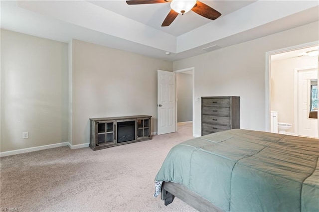 822 Blue Lake Dr, Mebane, NC 27302 - carpeted bedroom featuring a tray ceiling, ensuite bathroom, and a ceiling fan
