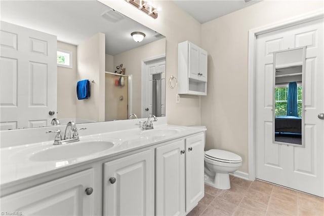 822 Blue Lake Dr, Mebane, NC 27302 - bathroom with double vanity, a shower with door, healthy amount of natural light, and tile patterned floors