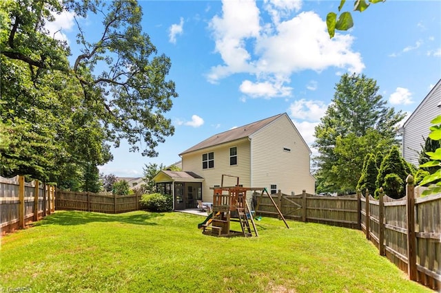822 Blue Lake Dr, Mebane, NC 27302 - back of house featuring a fenced backyard, a playground, and a sunroom