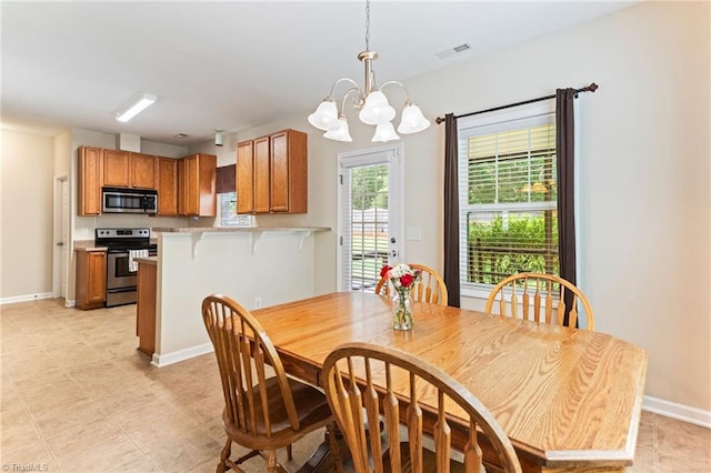 822 Blue Lake Dr, Mebane, NC 27302 - dining room featuring a chandelier and light tile patterned floors
