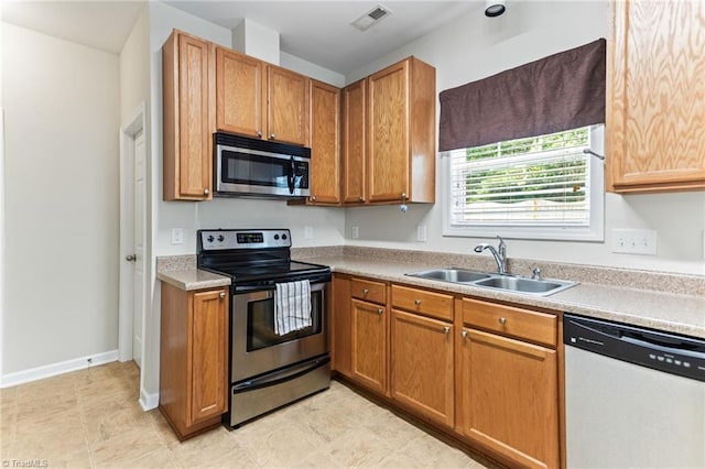 822 Blue Lake Dr, Mebane, NC 27302 - kitchen featuring appliances with stainless steel finishes, light countertops, and brown cabinets
