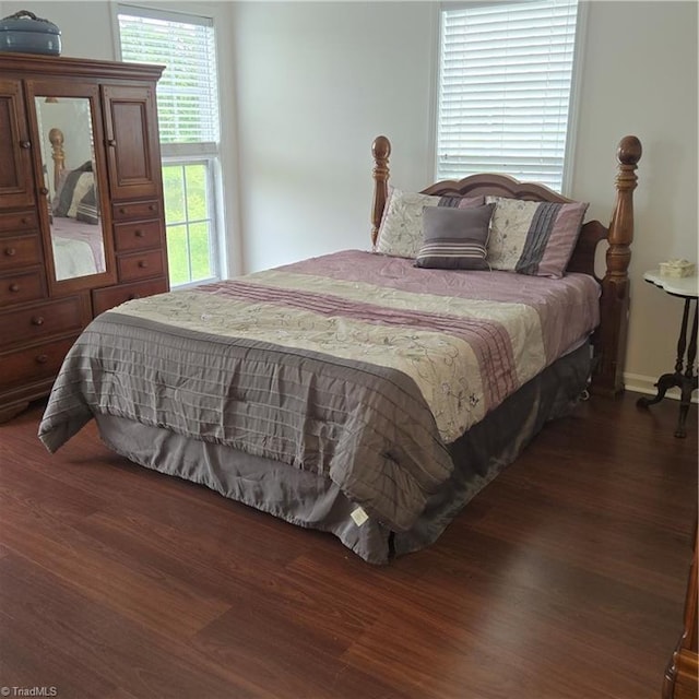 bedroom with dark wood finished floors