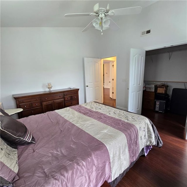 bedroom with a ceiling fan, a closet, visible vents, high vaulted ceiling, and wood finished floors