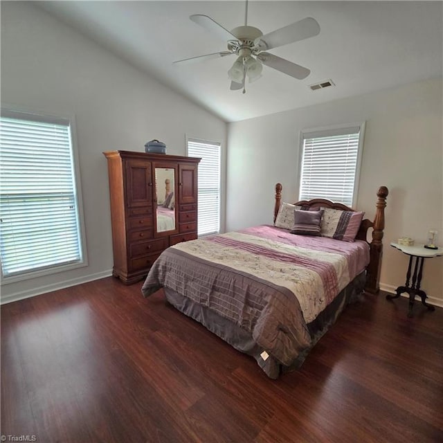 bedroom featuring vaulted ceiling, baseboards, dark wood-type flooring, and visible vents