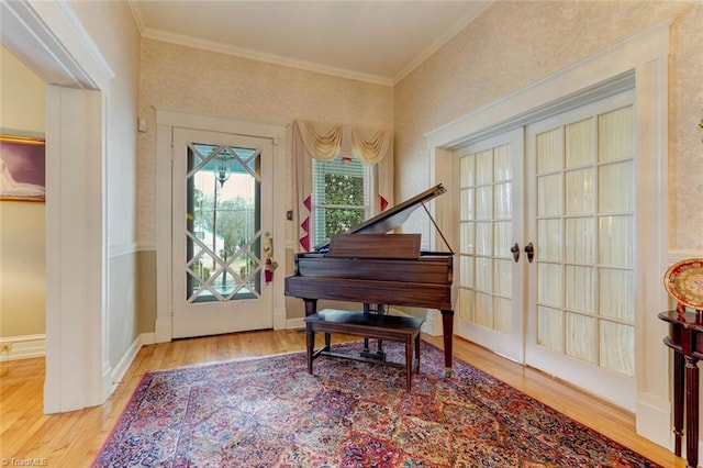 miscellaneous room with wood-type flooring, french doors, and ornamental molding